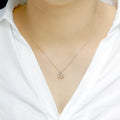Delicate Triangle Pendant with dancing Diamond and chain in 18K Yellow Gold