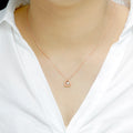 Delicate Triangle Pendant with dancing Diamond and chain in 18K Rose Gold