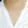 Delicate Oval Pendant with dancing Diamond and chain in 18K Yellow Gold
